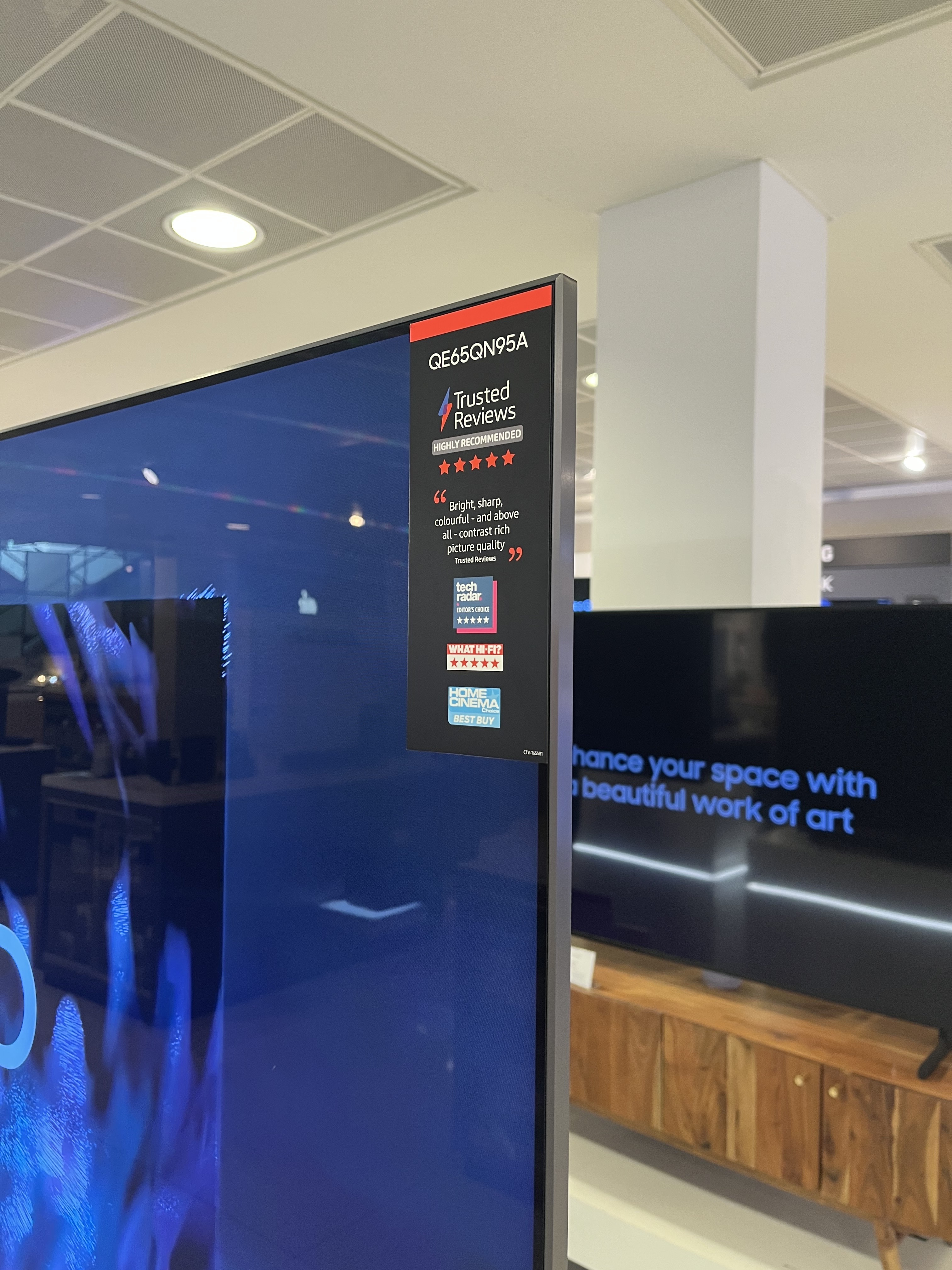 A TV display in store showing customer reviews and ratings from trusted review sites